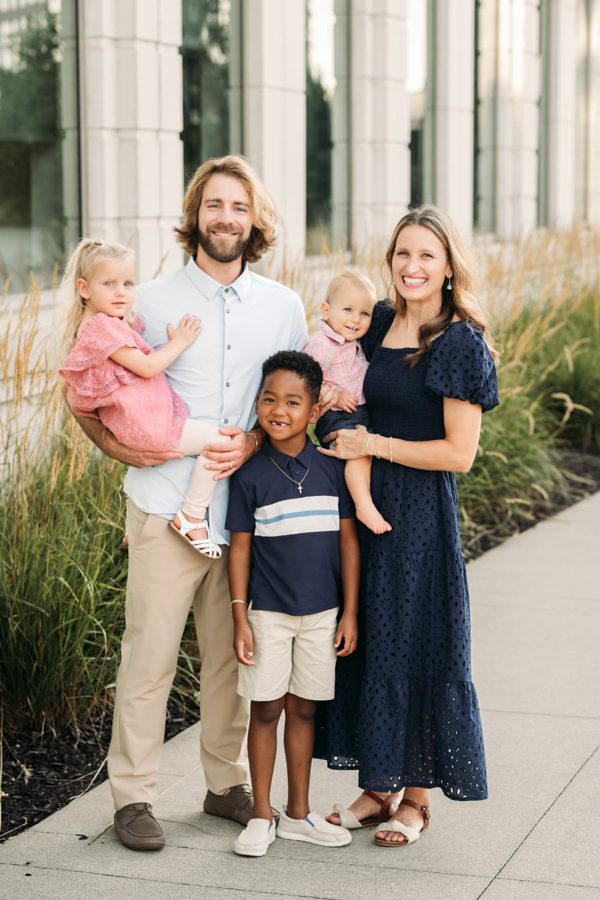 Parents holding their four children on a late summer evening — family photography in the Kansas City area