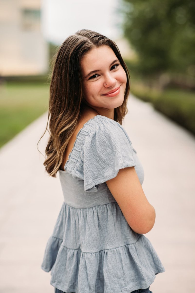 Senior girl in a blue ruffled top on a garden path — seniors photography in the Kansas City area
