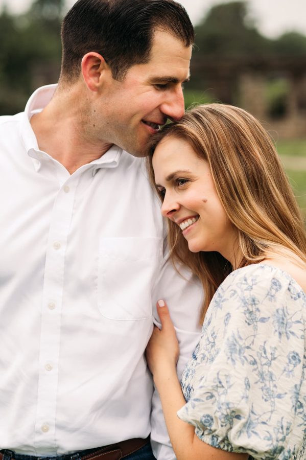 Husband and wife laughing close together during a family session — family photography in the Kansas City area